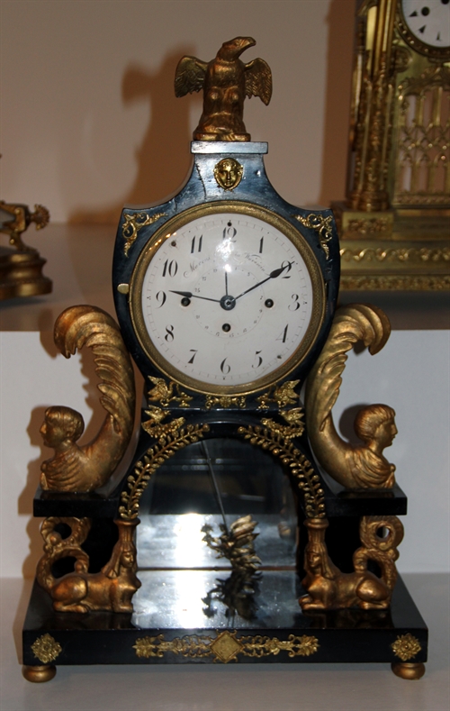 Standing clock with the two Ancient Egyptian sphinx at the bottom